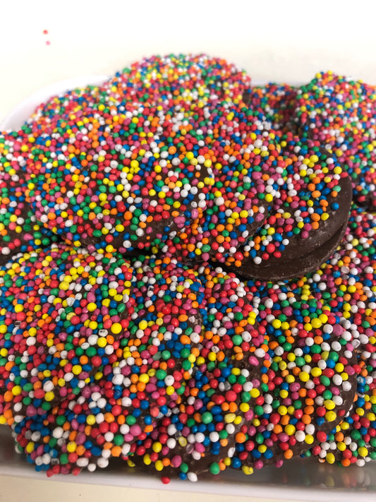 SelectSweets milk chocolate freckles topped with colorful candy sprinkles in close-up view